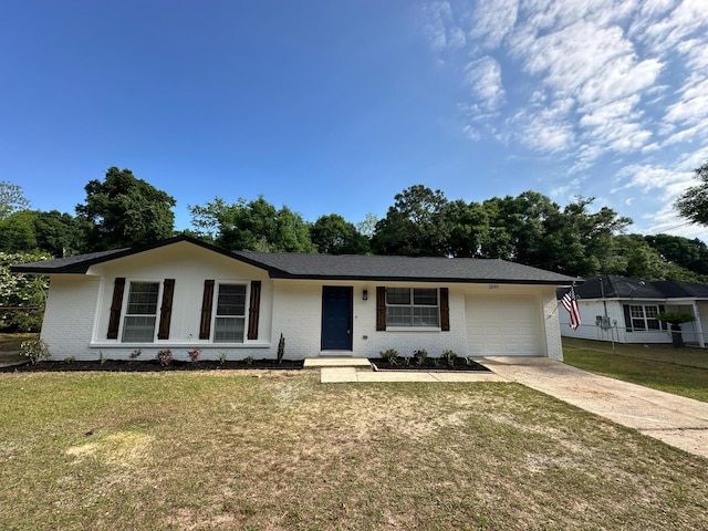 single story home with a garage, a front yard, driveway, and brick siding