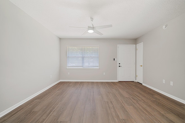 2899 Wisteria Ave, Crestview, FL 32539 - empty room with ceiling fan, wood finished floors, a textured ceiling, and baseboards