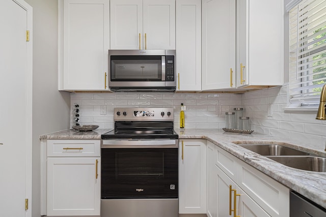 2899 Wisteria Ave, Crestview, FL 32539 - kitchen with appliances with stainless steel finishes, a sink, and white cabinetry