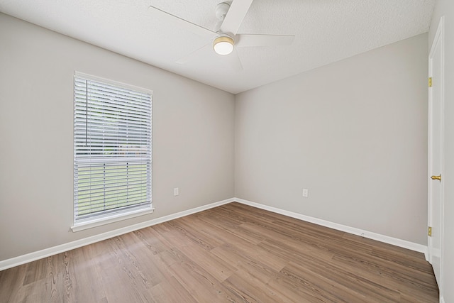 2899 Wisteria Ave, Crestview, FL 32539 - spare room with wood finished floors, plenty of natural light, and baseboards