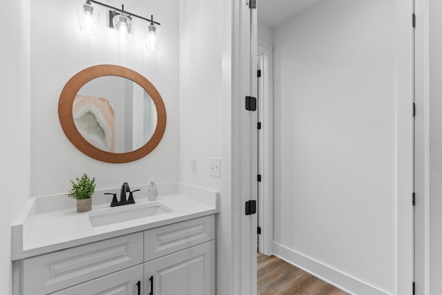 bathroom with wood finished floors and vanity