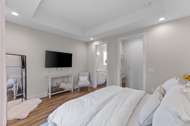 bedroom featuring recessed lighting, ensuite bathroom, wood finished floors, and baseboards