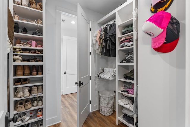 spacious closet featuring visible vents and wood finished floors
