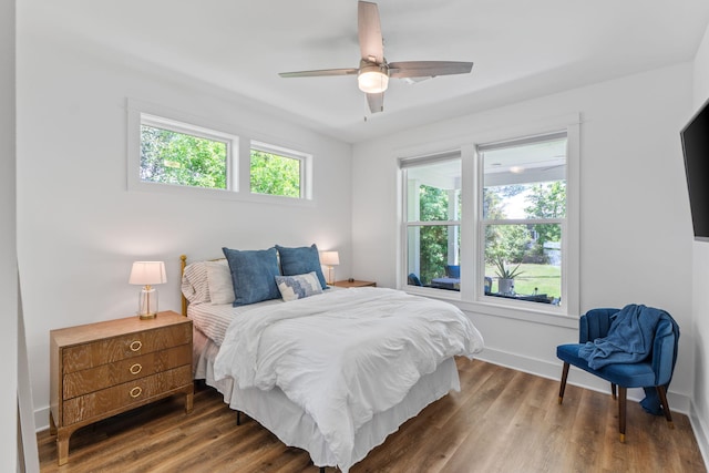 bedroom featuring ceiling fan, wood finished floors, and baseboards