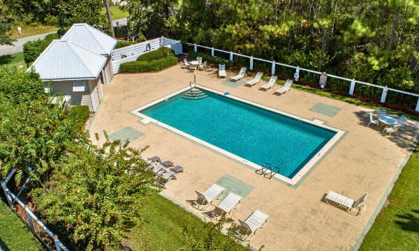 pool featuring fence and a patio area