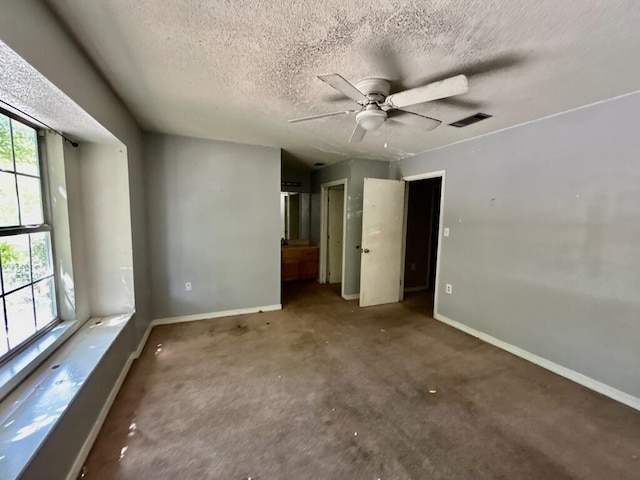 unfurnished bedroom with visible vents, baseboards, ceiling fan, a textured ceiling, and carpet flooring