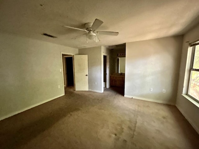 unfurnished room featuring carpet floors, baseboards, and ceiling fan