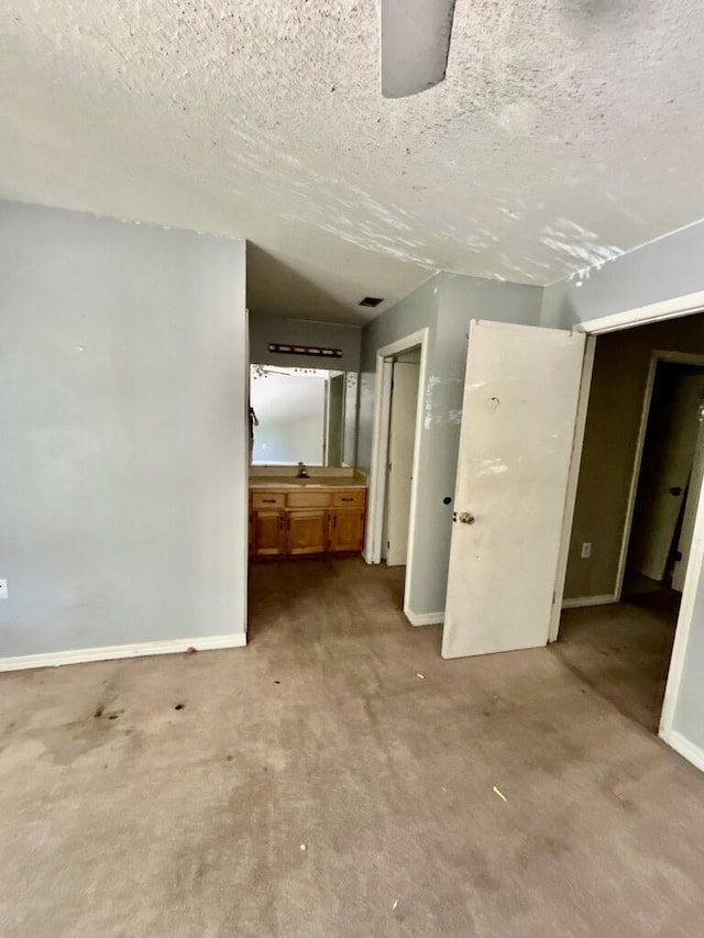 empty room featuring baseboards and a textured ceiling