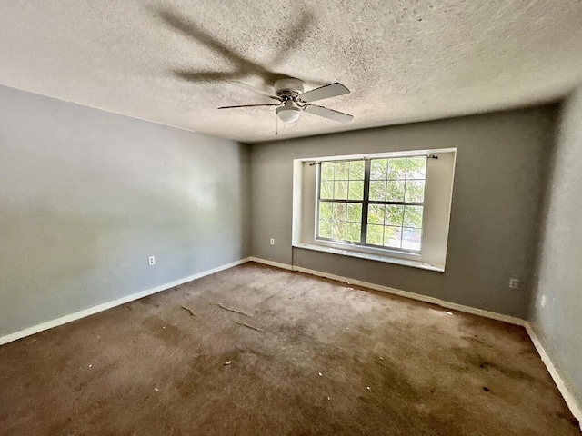 unfurnished room with baseboards, a ceiling fan, carpet, and a textured ceiling