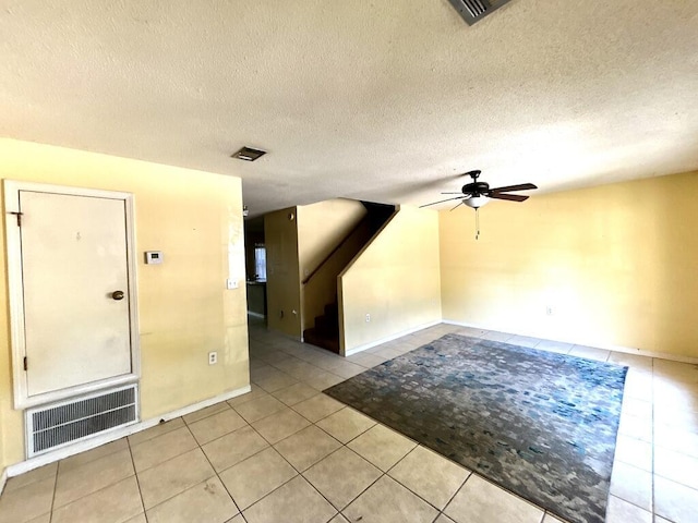unfurnished room with visible vents, ceiling fan, light tile patterned floors, and baseboards
