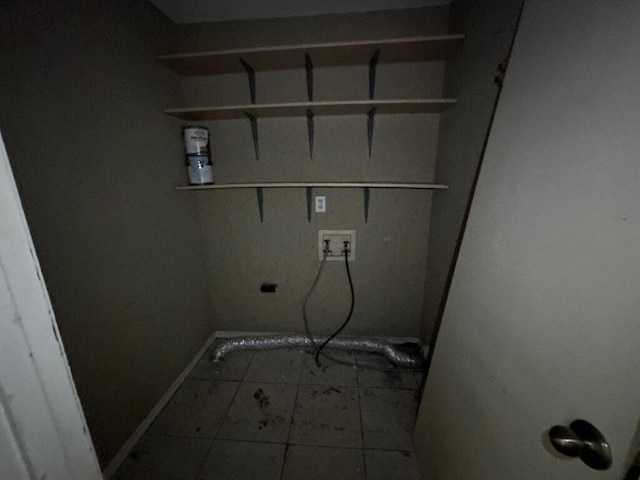 laundry area with tile patterned floors, hookup for a washing machine, laundry area, and baseboards