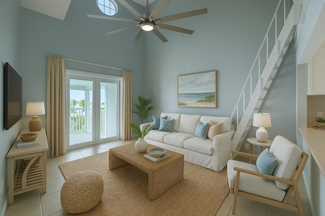 3600 Thomas Dr Unit D302, Panama City Beach, FL 32408 - living area featuring light tile patterned flooring, a towering ceiling, stairs, and ceiling fan