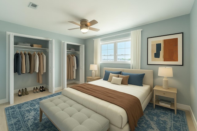 3600 Thomas Dr Unit D302, Panama City Beach, FL 32408 - bedroom with a ceiling fan, wood finished floors, two closets, baseboards, and visible vents