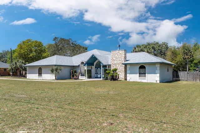 809 Main St, Destin, FL 32541 - ranch-style home featuring a front lawn, fence, and stucco siding