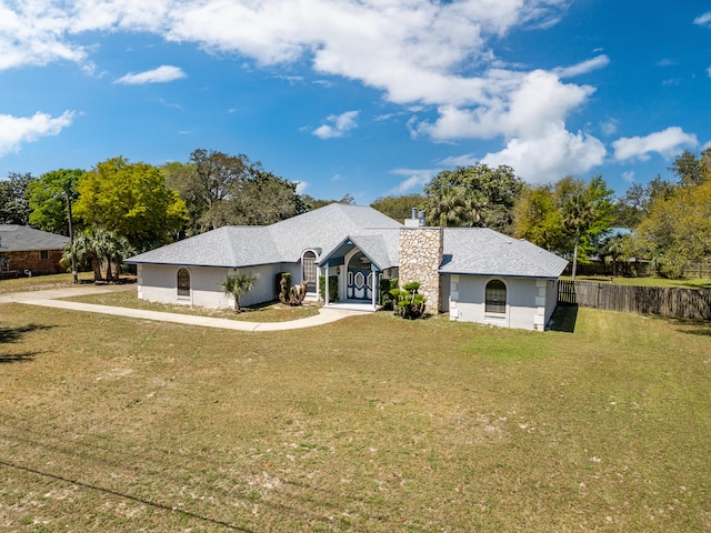 809 Main St, Destin, FL 32541 - view of front of home featuring a front yard, stucco siding, fence, and a chimney