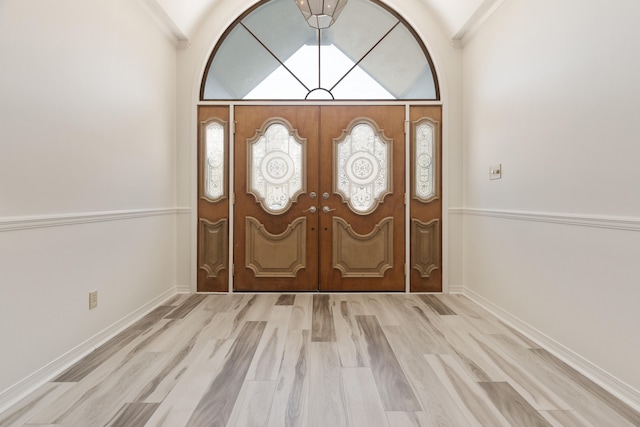 809 Main St, Destin, FL 32541 - foyer entrance featuring light wood-style floors, baseboards, vaulted ceiling, and french doors