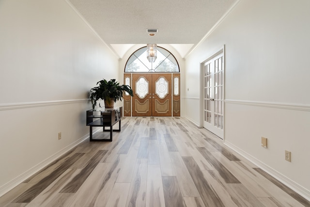 809 Main St, Destin, FL 32541 - foyer with visible vents, baseboards, ornamental molding, wood finished floors, and lofted ceiling