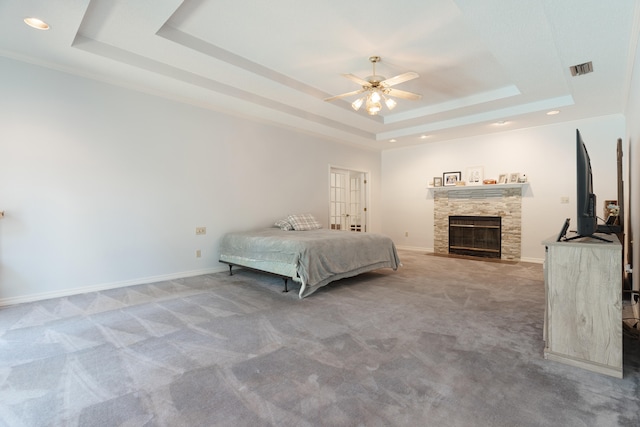 809 Main St, Destin, FL 32541 - bedroom featuring baseboards, a fireplace, carpet floors, visible vents, and a raised ceiling