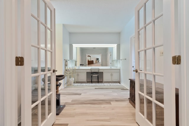 809 Main St, Destin, FL 32541 - bathroom with french doors, double vanity, and wood finished floors
