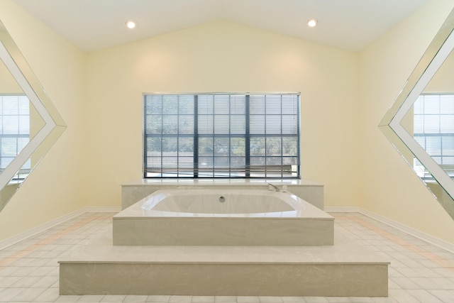 809 Main St, Destin, FL 32541 - bathroom featuring a bath, tile patterned floors, baseboards, and lofted ceiling