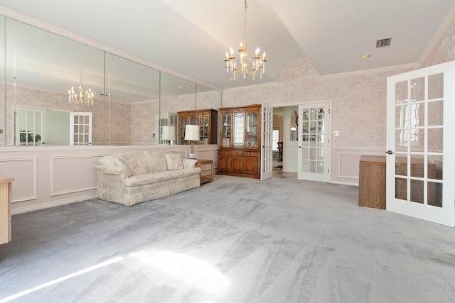 809 Main St, Destin, FL 32541 - living room featuring a decorative wall, ornamental molding, carpet, a chandelier, and vaulted ceiling
