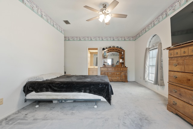 809 Main St, Destin, FL 32541 - carpeted bedroom with visible vents, baseboards, ceiling fan, and connected bathroom