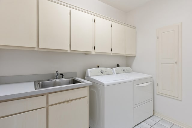 809 Main St, Destin, FL 32541 - washroom with baseboards, light tile patterned floors, cabinet space, washer and dryer, and a sink