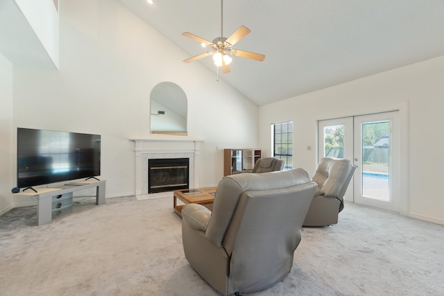 809 Main St, Destin, FL 32541 - carpeted living room with baseboards, a tiled fireplace, french doors, ceiling fan, and high vaulted ceiling