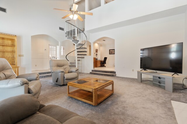 809 Main St, Destin, FL 32541 - living area featuring arched walkways, a ceiling fan, carpet, and stairway