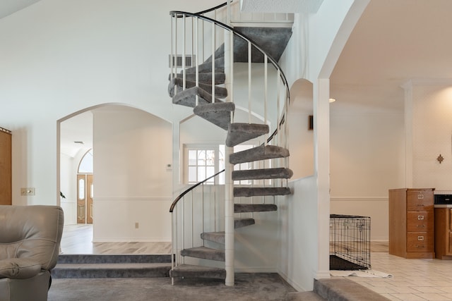 809 Main St, Destin, FL 32541 - stairway featuring arched walkways, a high ceiling, and baseboards