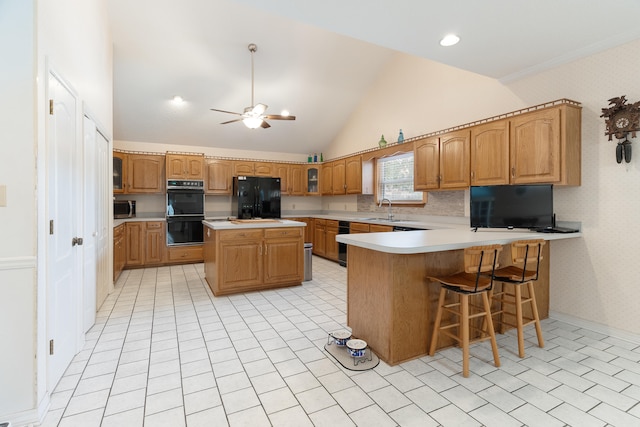 809 Main St, Destin, FL 32541 - kitchen with a peninsula, light countertops, a ceiling fan, black appliances, and a sink