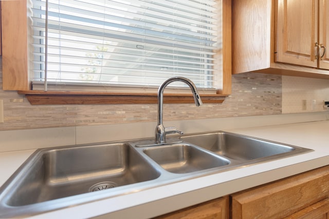 809 Main St, Destin, FL 32541 - details with a sink, backsplash, and light countertops