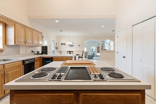 809 Main St, Destin, FL 32541 - kitchen featuring arched walkways, black dishwasher, light countertops, wine cooler, and a kitchen island