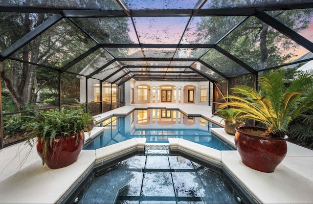 pool featuring an in ground hot tub and a patio area