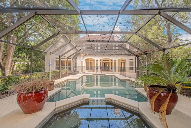237 Matties Way, Destin, FL 32541 - view of swimming pool featuring a pool with connected hot tub, a patio area, a lanai, and french doors