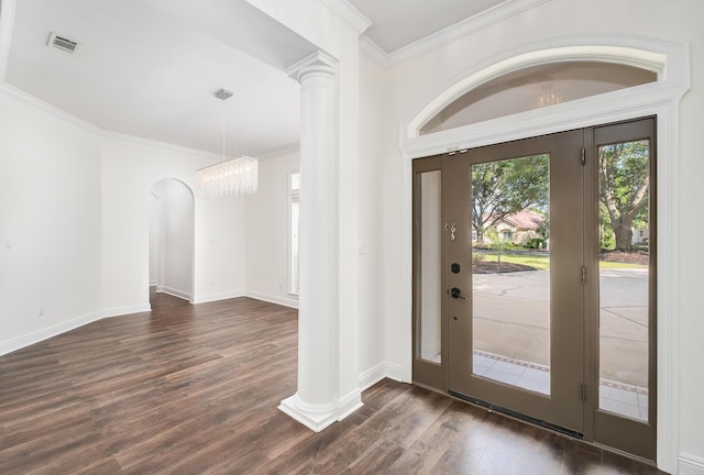 237 Matties Way, Destin, FL 32541 - foyer entrance with dark wood finished floors, crown molding, decorative columns, baseboards, and a chandelier