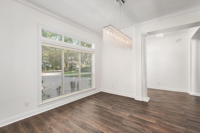 237 Matties Way, Destin, FL 32541 - unfurnished dining area featuring decorative columns, dark wood-style floors, baseboards, crown molding, and a chandelier