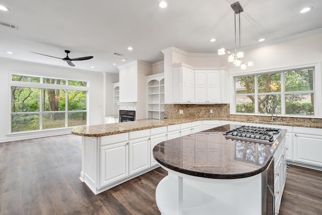 237 Matties Way, Destin, FL 32541 - kitchen featuring stainless steel gas cooktop, ceiling fan, plenty of natural light, ornamental molding, and a kitchen island