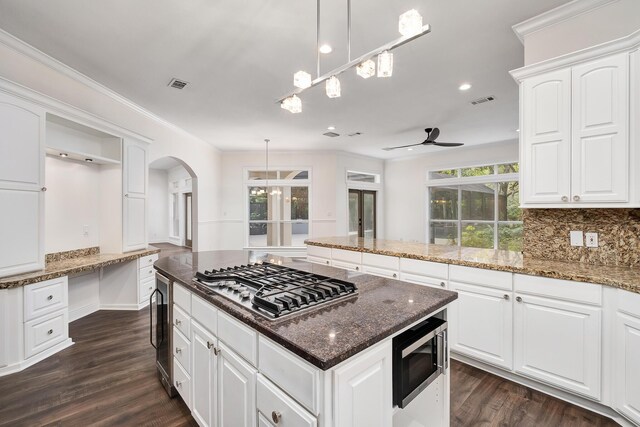 237 Matties Way, Destin, FL 32541 - kitchen featuring appliances with stainless steel finishes, beverage cooler, arched walkways, ceiling fan, and a center island