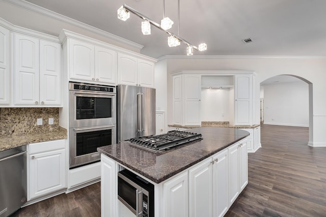 237 Matties Way, Destin, FL 32541 - kitchen featuring stainless steel appliances, open shelves, arched walkways, crown molding, and dark wood-style floors