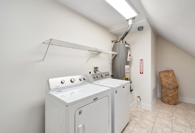 237 Matties Way, Destin, FL 32541 - washroom with washing machine and dryer, water heater, light tile patterned floors, and baseboards