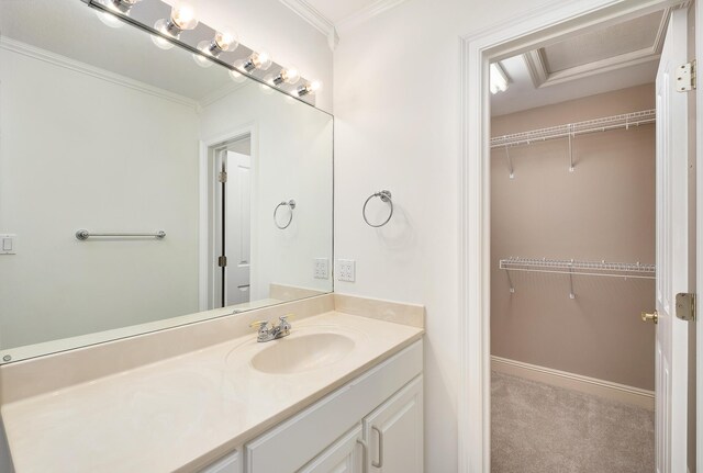 237 Matties Way, Destin, FL 32541 - bathroom with vanity, a spacious closet, crown molding, and baseboards