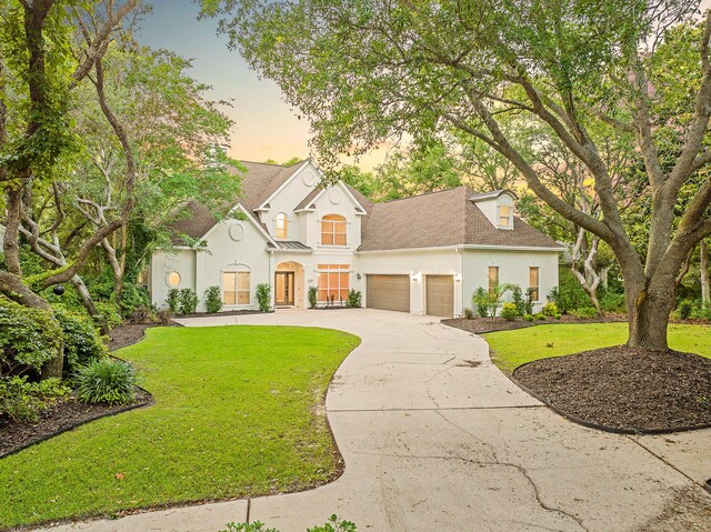 237 Matties Way, Destin, FL 32541 - view of front facade featuring stucco siding, a garage, driveway, and a front yard