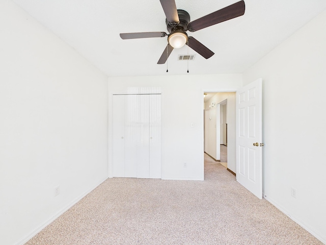 unfurnished bedroom featuring carpet, visible vents, and baseboards