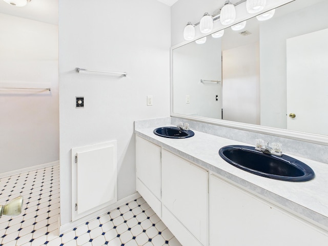 full bathroom featuring tile patterned floors, double vanity, visible vents, and a sink
