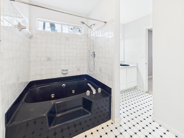 full bathroom featuring a combined bath / shower with jetted tub, vanity, and baseboards