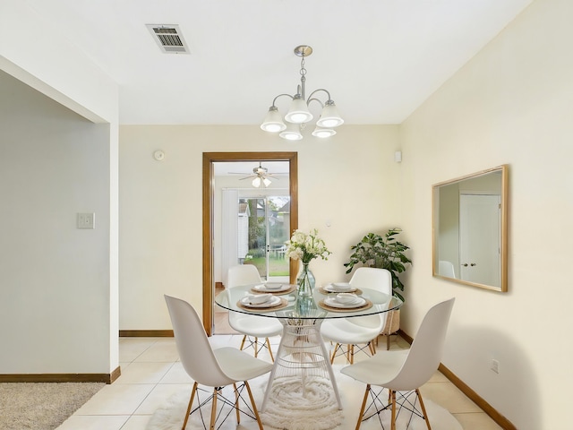 dining space featuring light tile patterned floors, visible vents, baseboards, and ceiling fan with notable chandelier