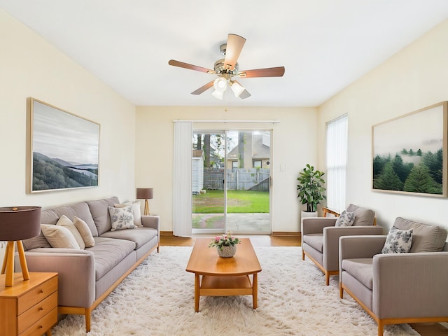 living room with a ceiling fan and wood finished floors