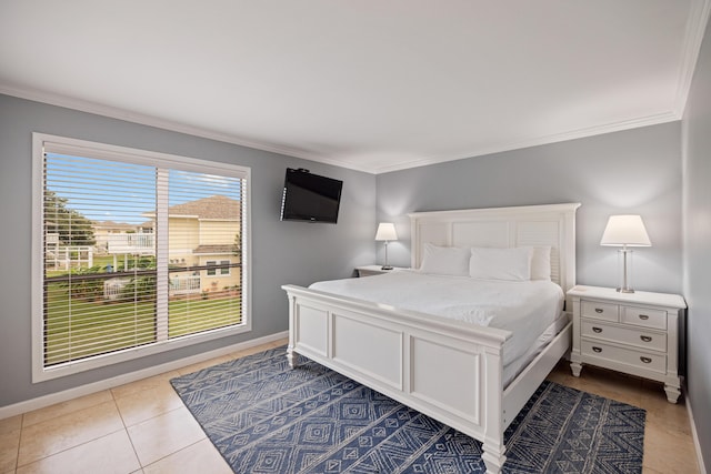 bedroom featuring baseboards, ornamental molding, and tile patterned flooring