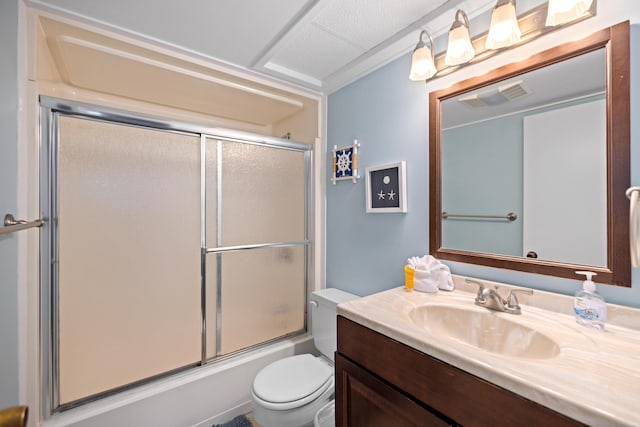bathroom featuring toilet, enclosed tub / shower combo, vanity, and visible vents